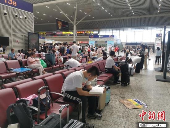 郑州东站候车厅内，一位正在读书的旅客，他告诉记者，除了向家人平安，还需静心等待。　李明明 摄