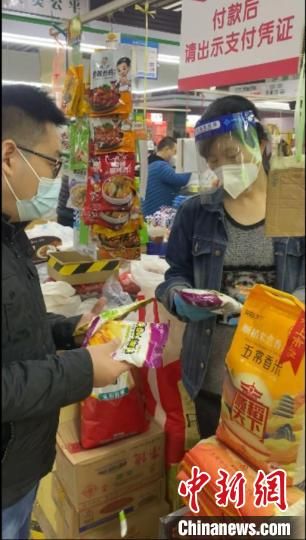 　图为范艳涛(左)在河南郑州超市采购油条膨松剂。　受访者供图
